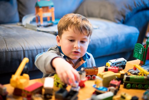 Boy playing with small cars