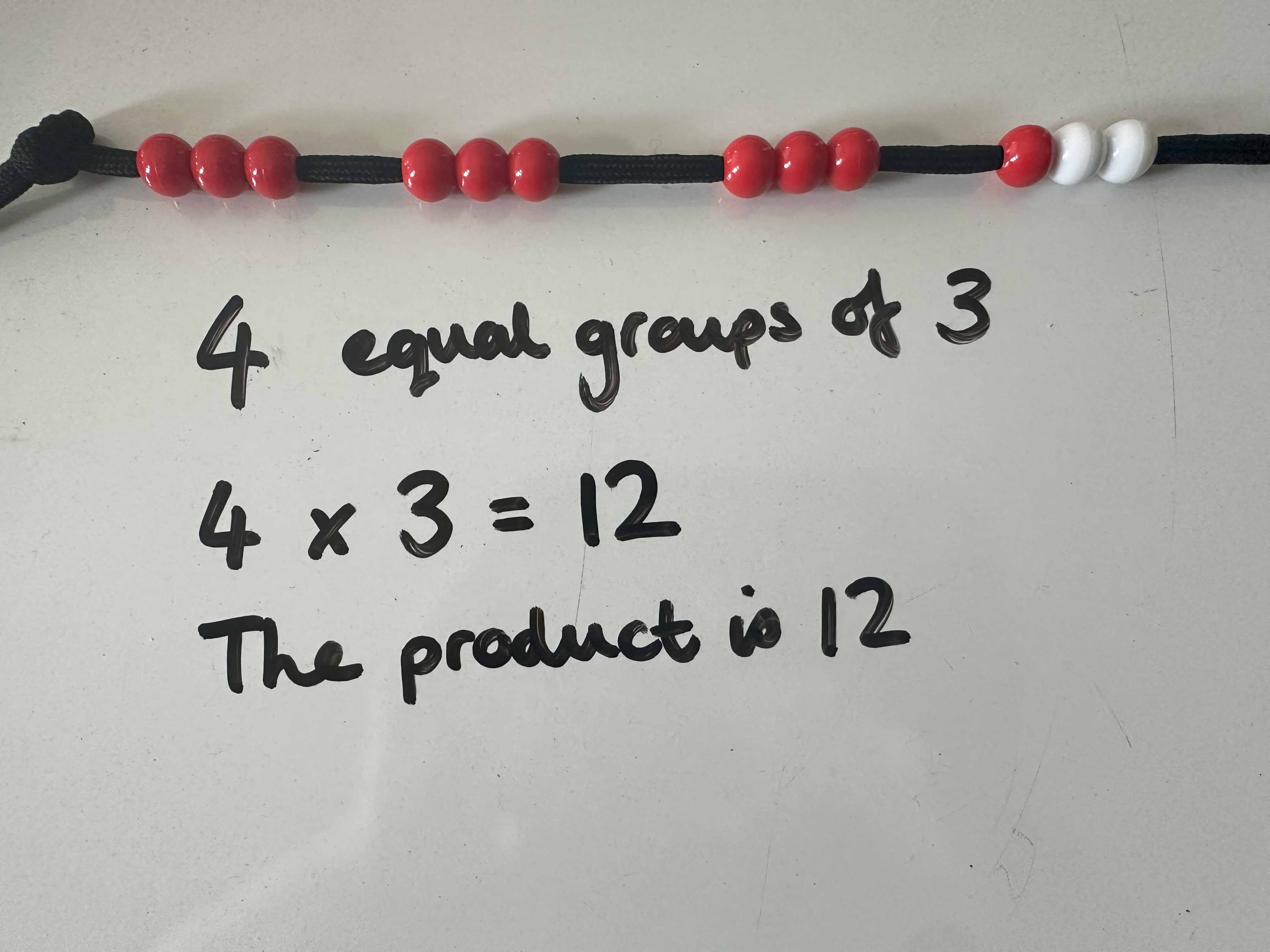 "4 equal groups of 3, 4x3-12, the product is 12"