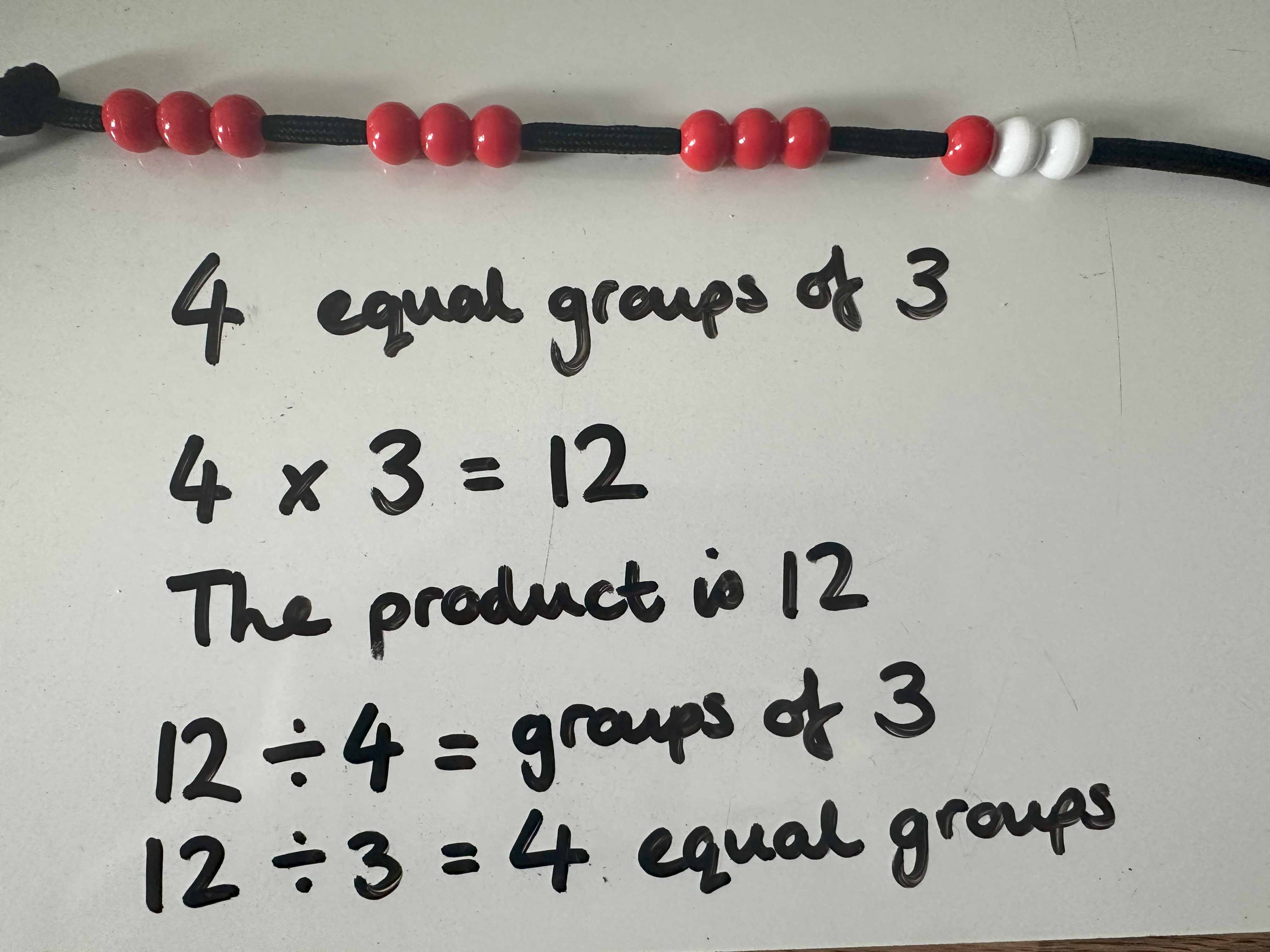 Maths equations written in black pen