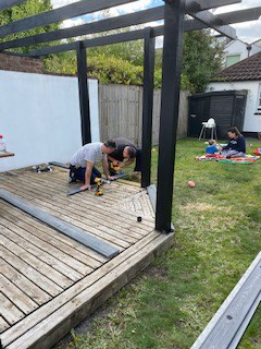 People laying garden decking