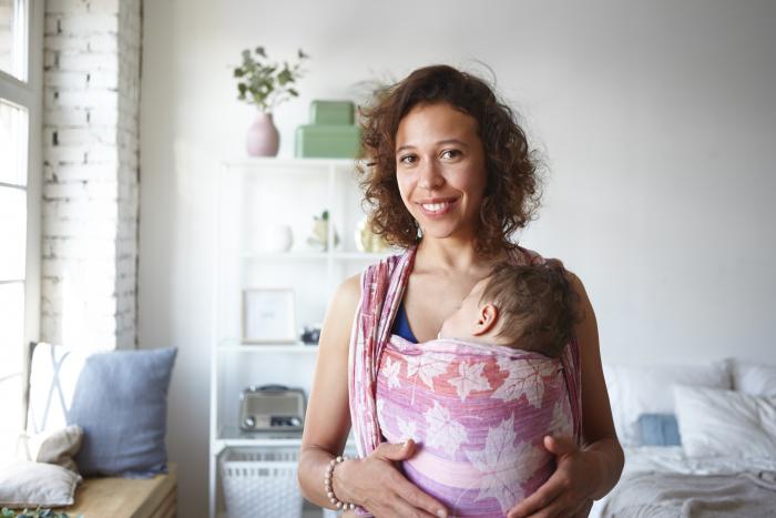 Woman with baby and baby carrier 