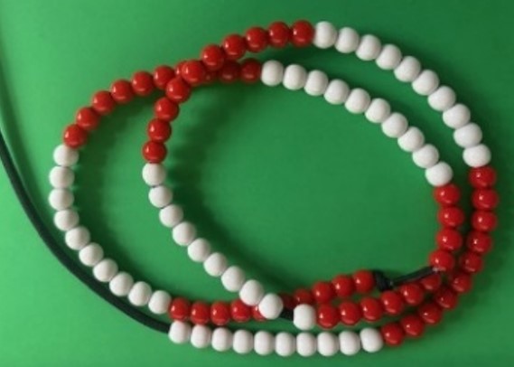 Red and white beads on green background