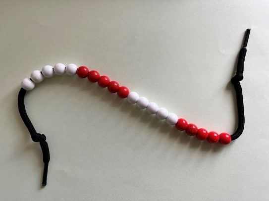 Red and white beads on white background