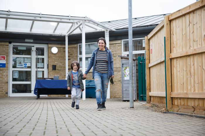 Mother and child walking in front of Early Years education setting