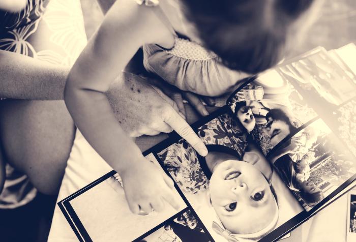 Mother and daughter looking at photo album