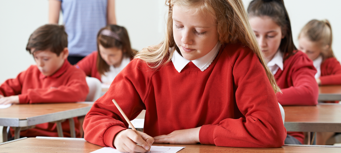 Girl in red jumper holding pencil 