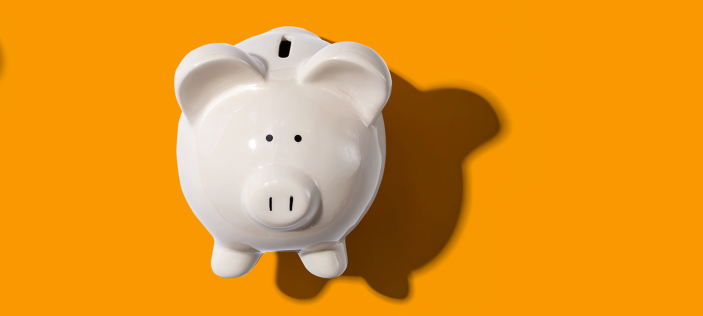 Piggy bank on yellow background