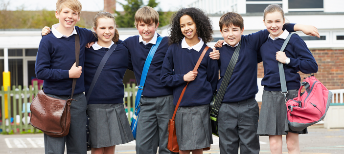 Happy pupils outside school setting 