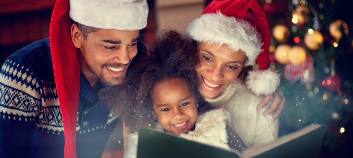 Family enjoying Christmas book