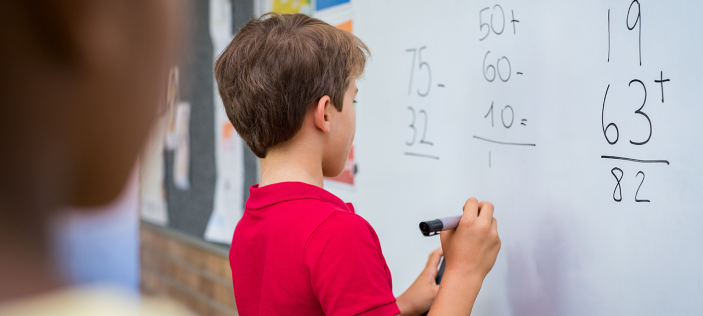 Child writing on whiteboard