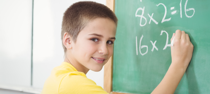 Child writing on blackboard