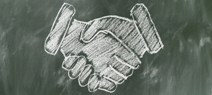 Blackboard drawing of shaking hands 