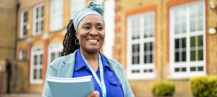 woman of colour in front of a school