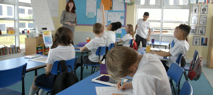 Classroom with students in uniform and teacher