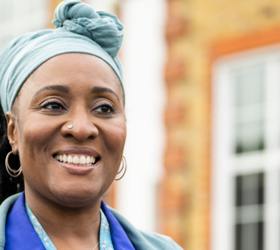 woman of colour in front of a school