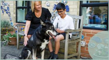visually impaired boy, dog and teacher