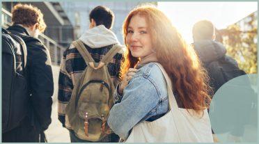 teenage girl walking along with a bag