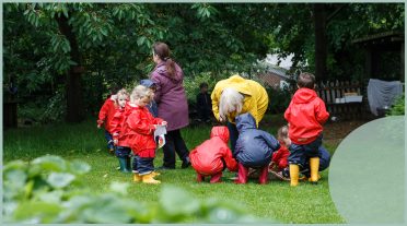 early years children in a group in macs outside