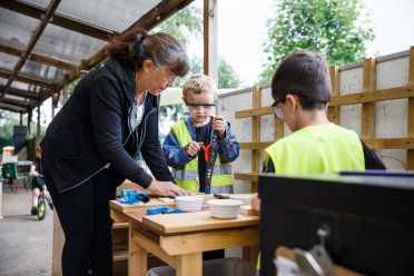 early years practitioner with children outside