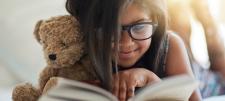 The power of short reads: quality reading experiences when time is short Girl reading book with teddy