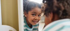 The moral imperative: creating a curriculum that develops identity, broadens horizons and enables success for all Young child looking back at us through her reflection in a mirror