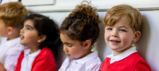 Who is eligible for pupil premium funding? Happy looking Early Years children