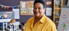 Into the world of wellbeing Adult in Early Years class, wearing yellow
