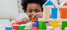 Home visits for all! Child playing with blocks