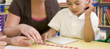 Supporting pupils with SEND in the maths classroom Child with adult at desk