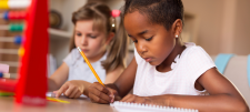 I have a vision - effective assessment of children’s confidence in their arithmetical proficiency Girl writing in book with pencil